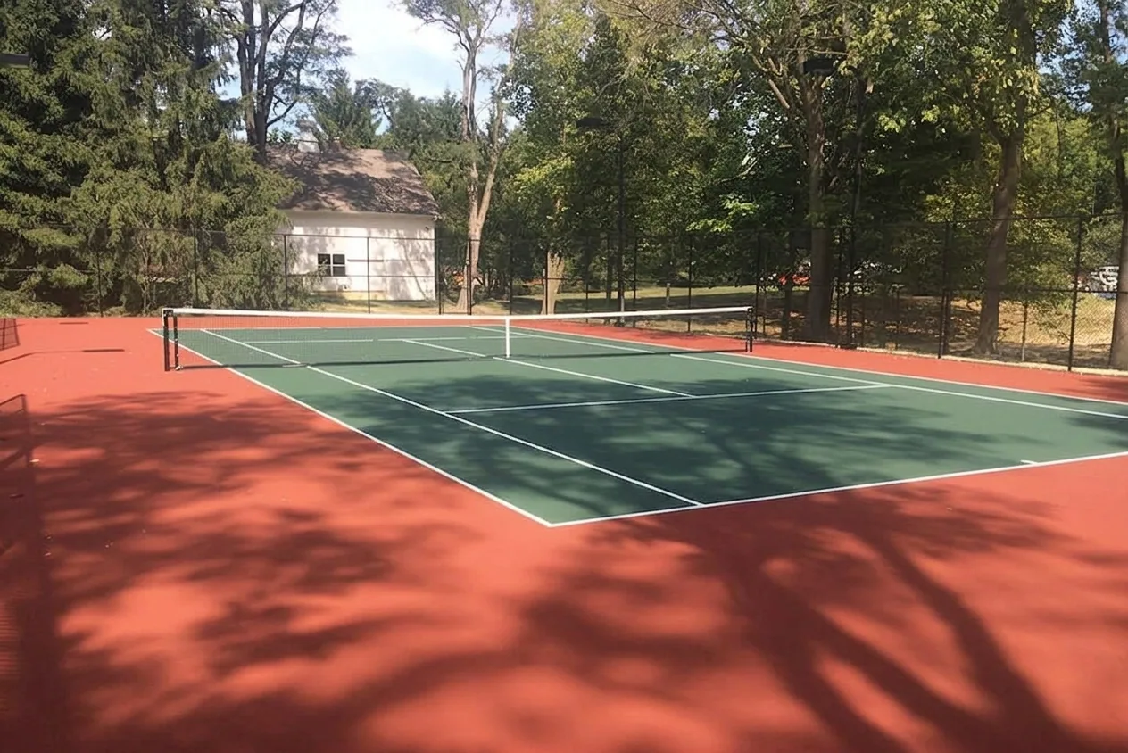 The finished result of professional tennis court resurfacing: the completed work looking clean, — Peoria, IL