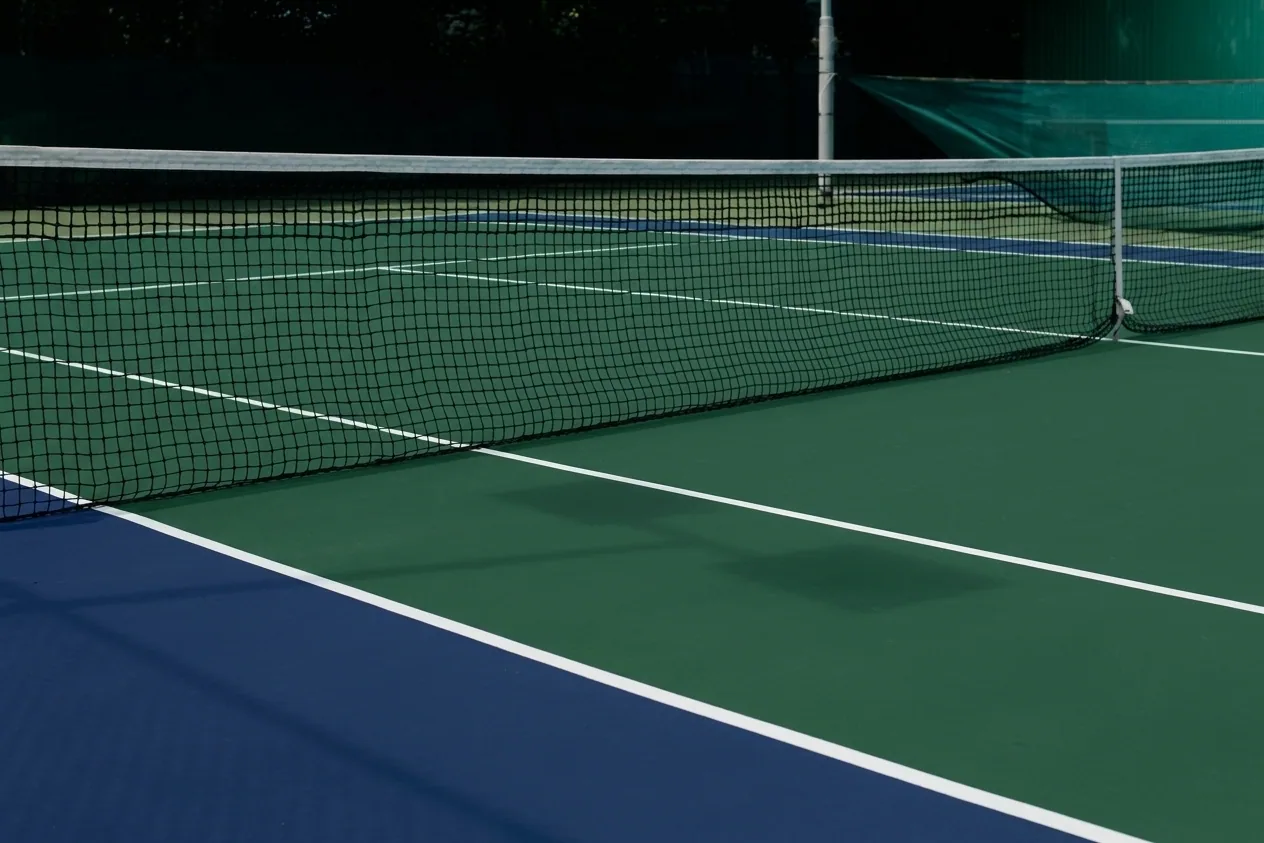 The finished result of professional tennis court resurfacing: the completed work looking clean, — Peoria, IL